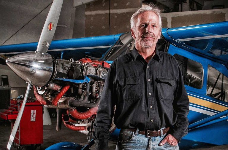 A private pilot and mechanic standing in front of an airplane