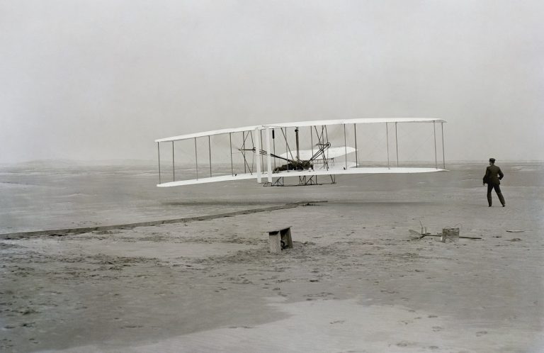 The historic photo captured by John T. Daniels of the Wright Brothers powered first flight - First Flight: the Wright Brothers